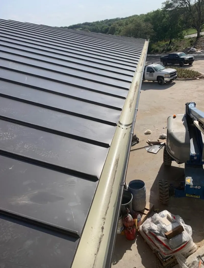 Standing seam panel and gutter detail on a metal roofing jobsite in Fairfield
